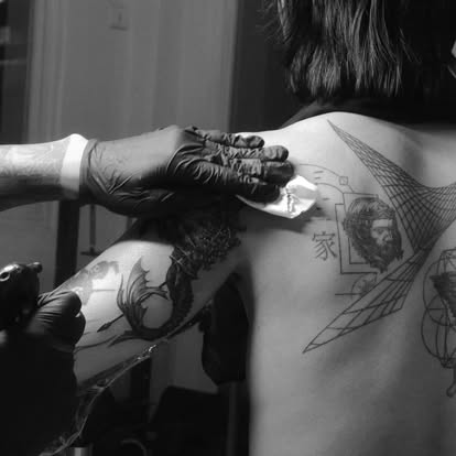 John Gyi tattooing in the studio