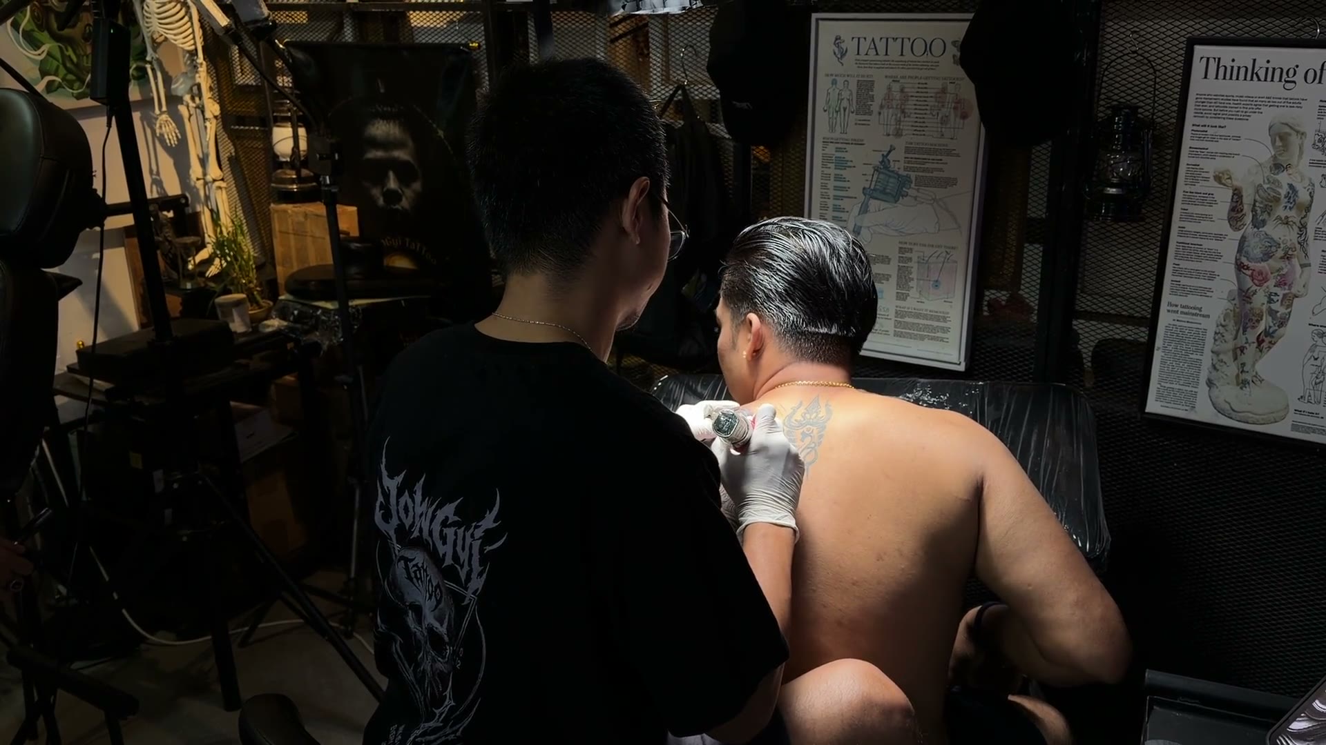 John Gyi tattooing in the studio